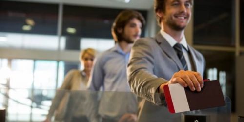 businessman-standing-with-boarding-pass-check-counter_107420-63615 (1)